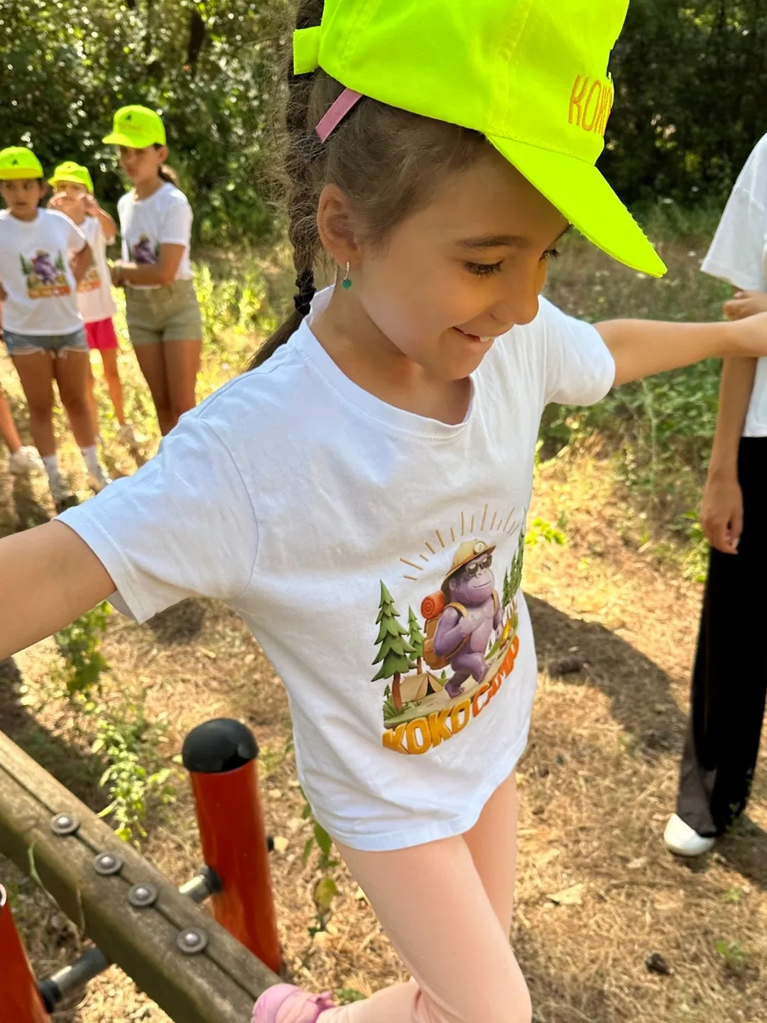 A girl balancing on a log in the woods
