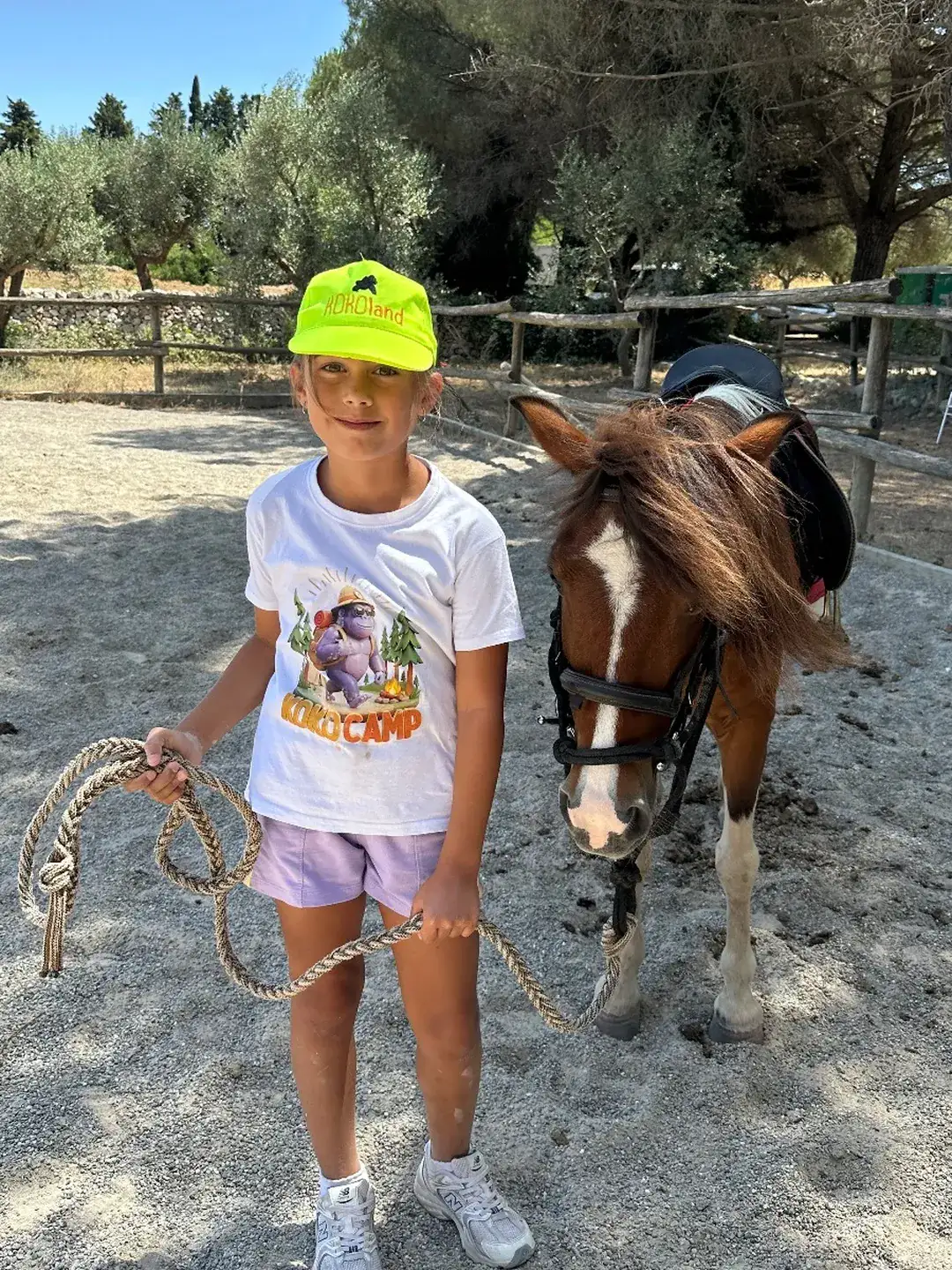 A girl leading a pony by hand