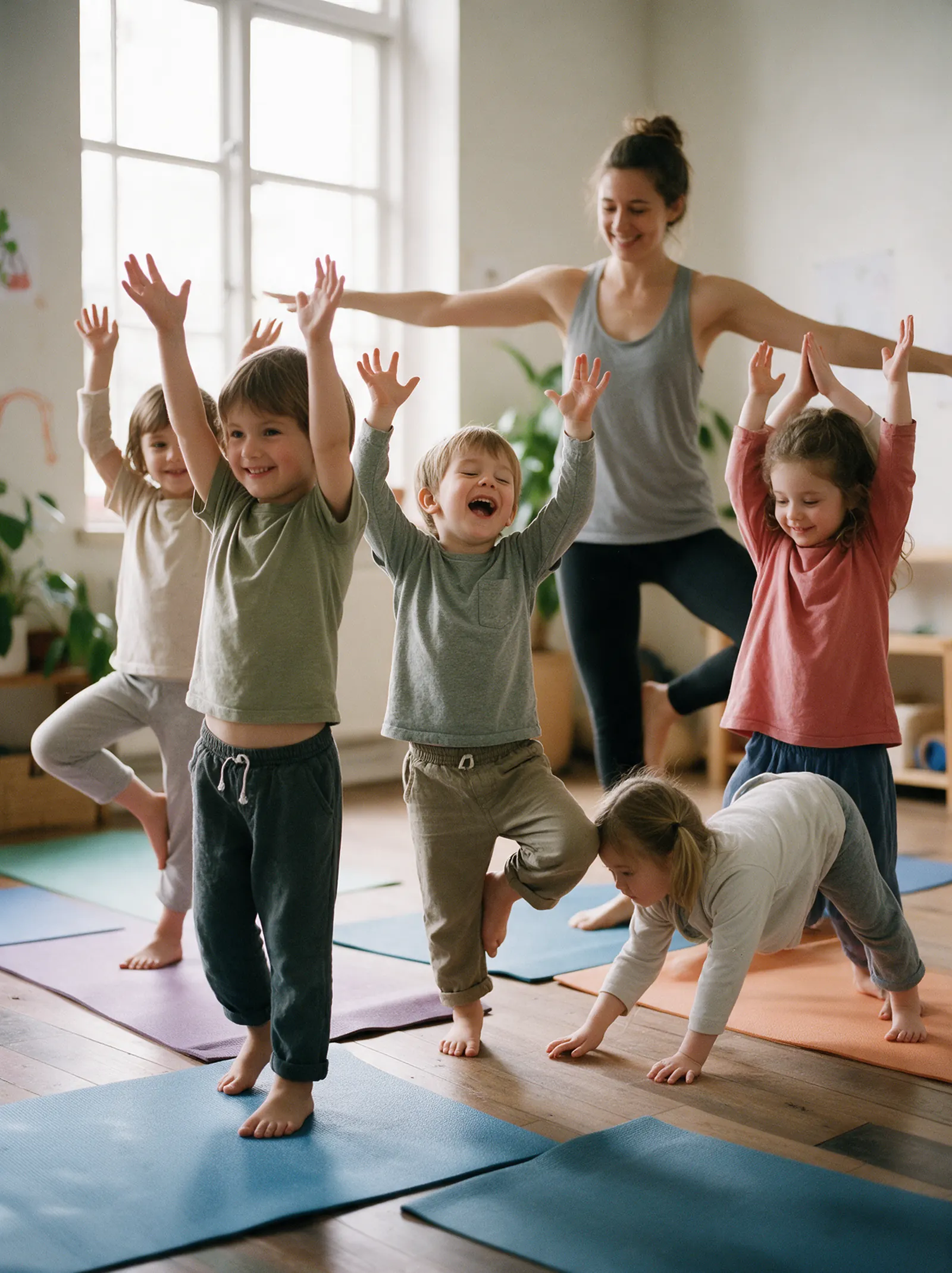 Children doing animal yoga poses on colourful mats