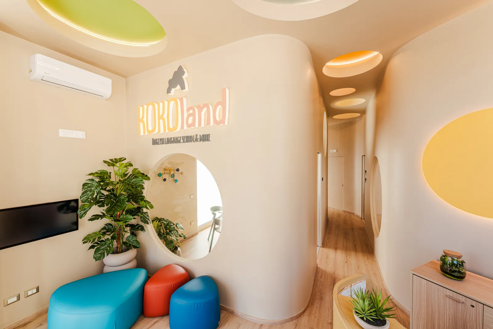 Reception of the KOKOland English school in Via Fiume 6, Monopoli, with colourful poufs and the KOKOland sign