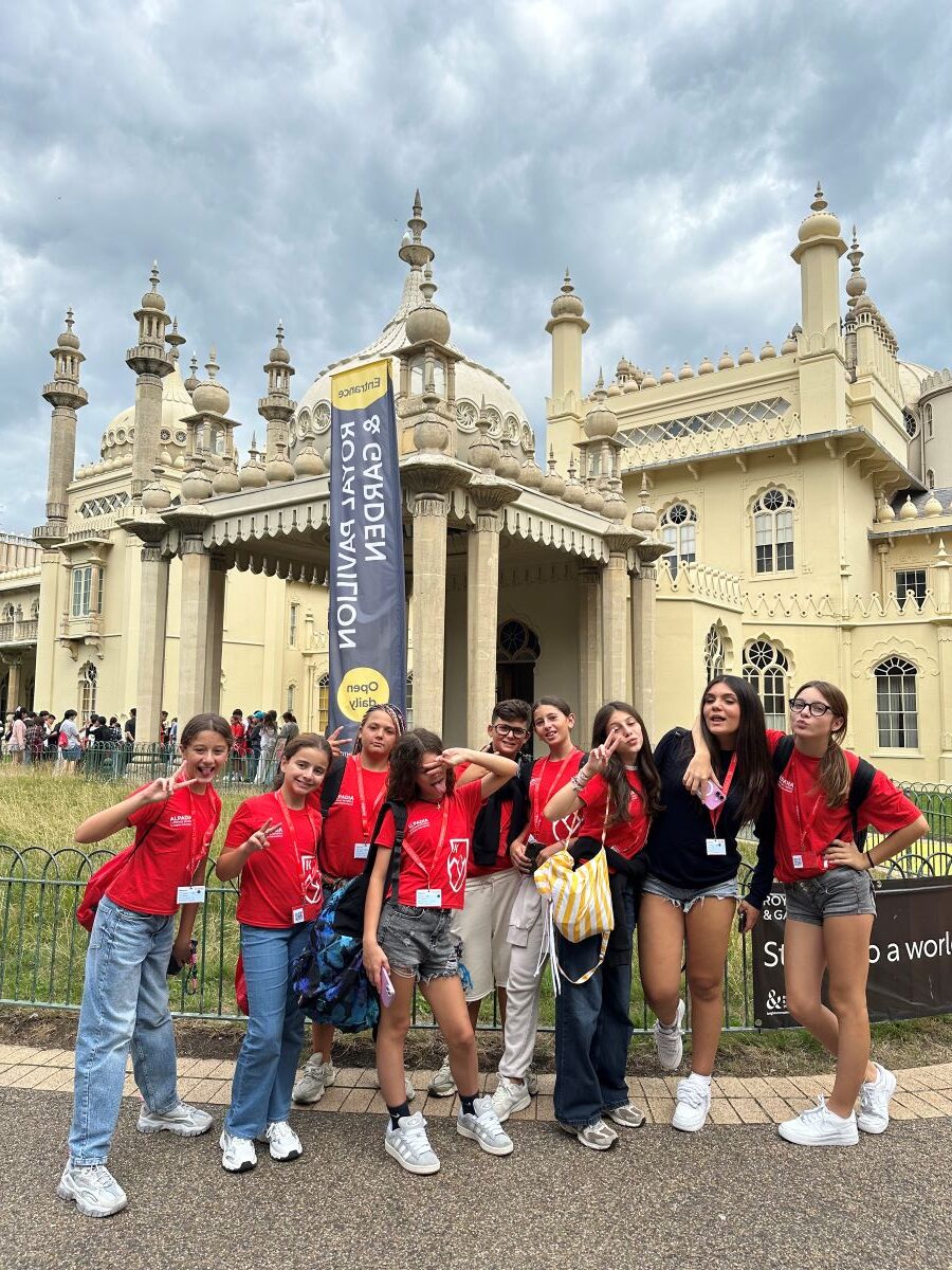 Group in red T-shirts in front of the Royal Pavilion in Brighton during the study holiday