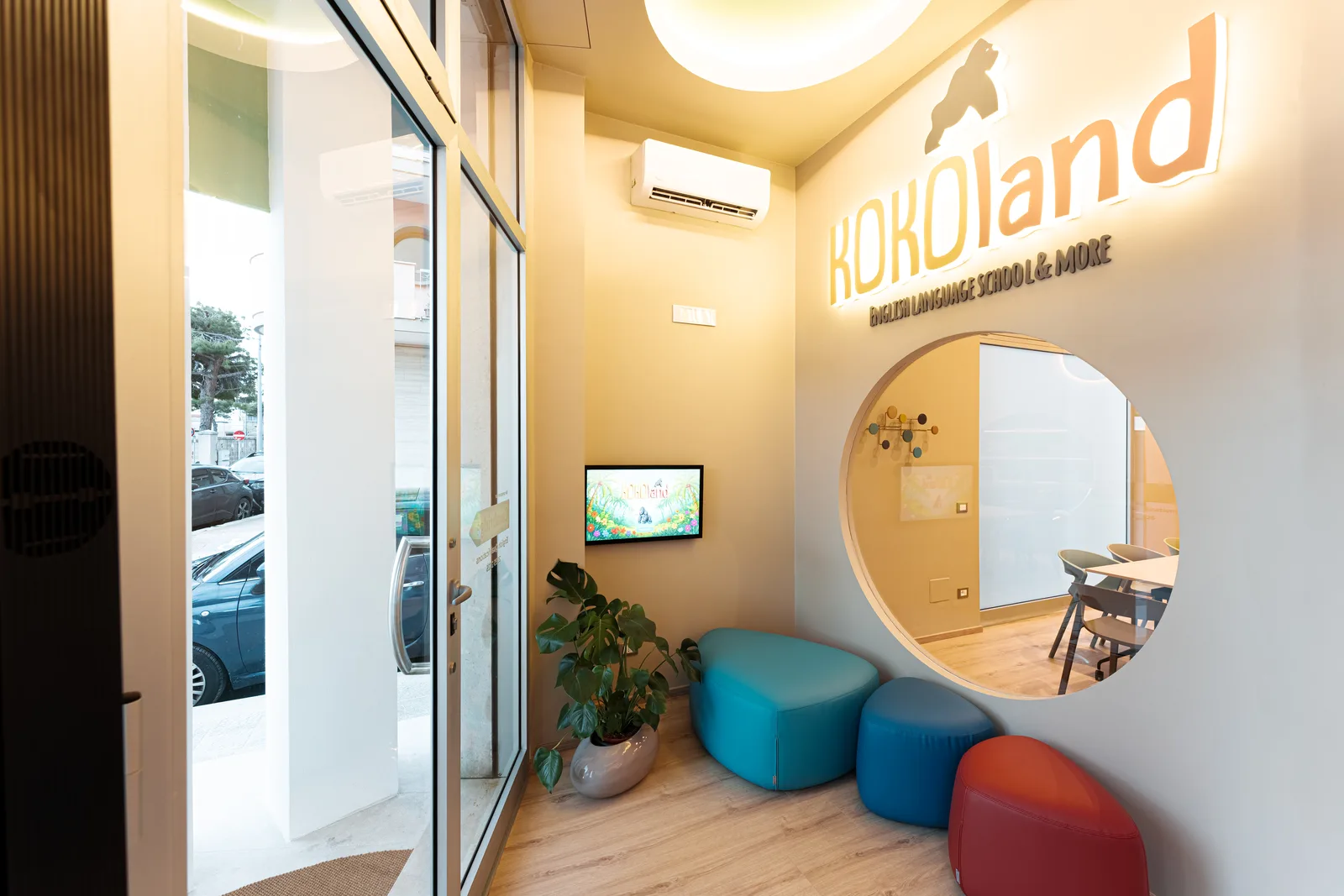 Reception of the KOKOland English school in Via Fiume 6, Monopoli, with colourful poufs and the KOKOland sign